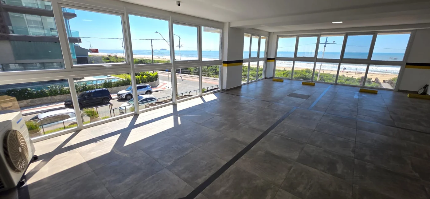 Living do apartamento do Brava Prime, com janelões voltados para o mar